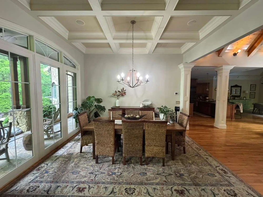 Formal dining room with a coffered ceiling and freshly painted walls and trim