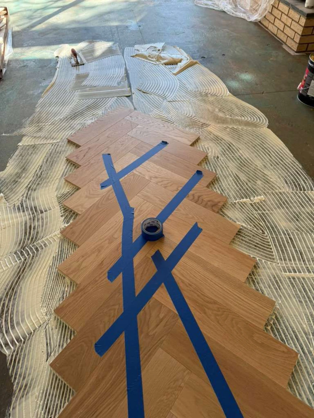 Herringbone hardwood dry-laid and taped out before installation